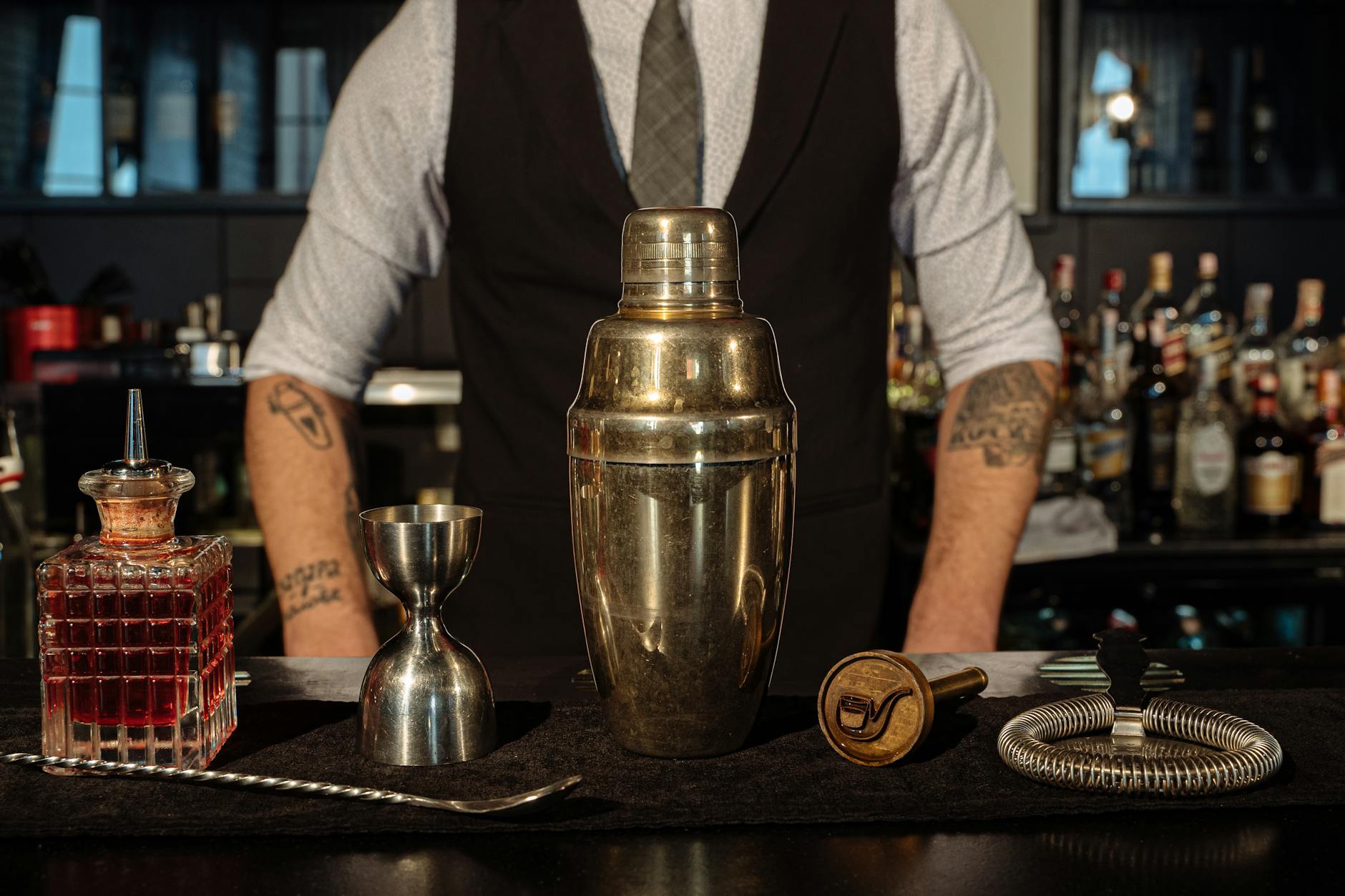 Bartender stirring a cocktail behind a Miami bar