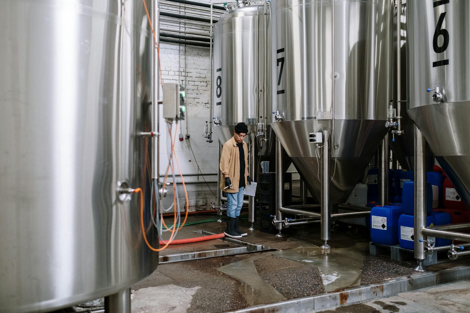 Stainless fermentation tanks inside a Miami craft brewery