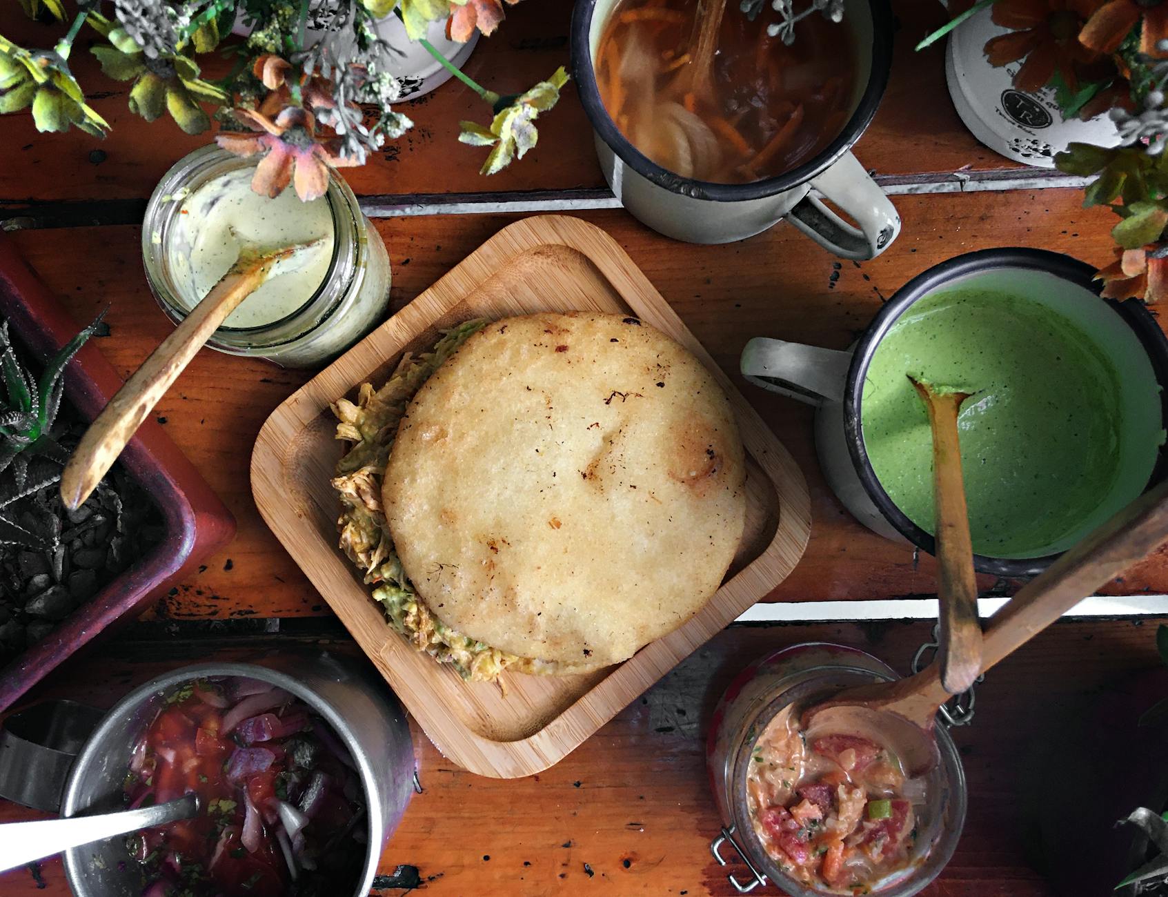 Venezuelan arepas filled and stacked on a plate in Miami