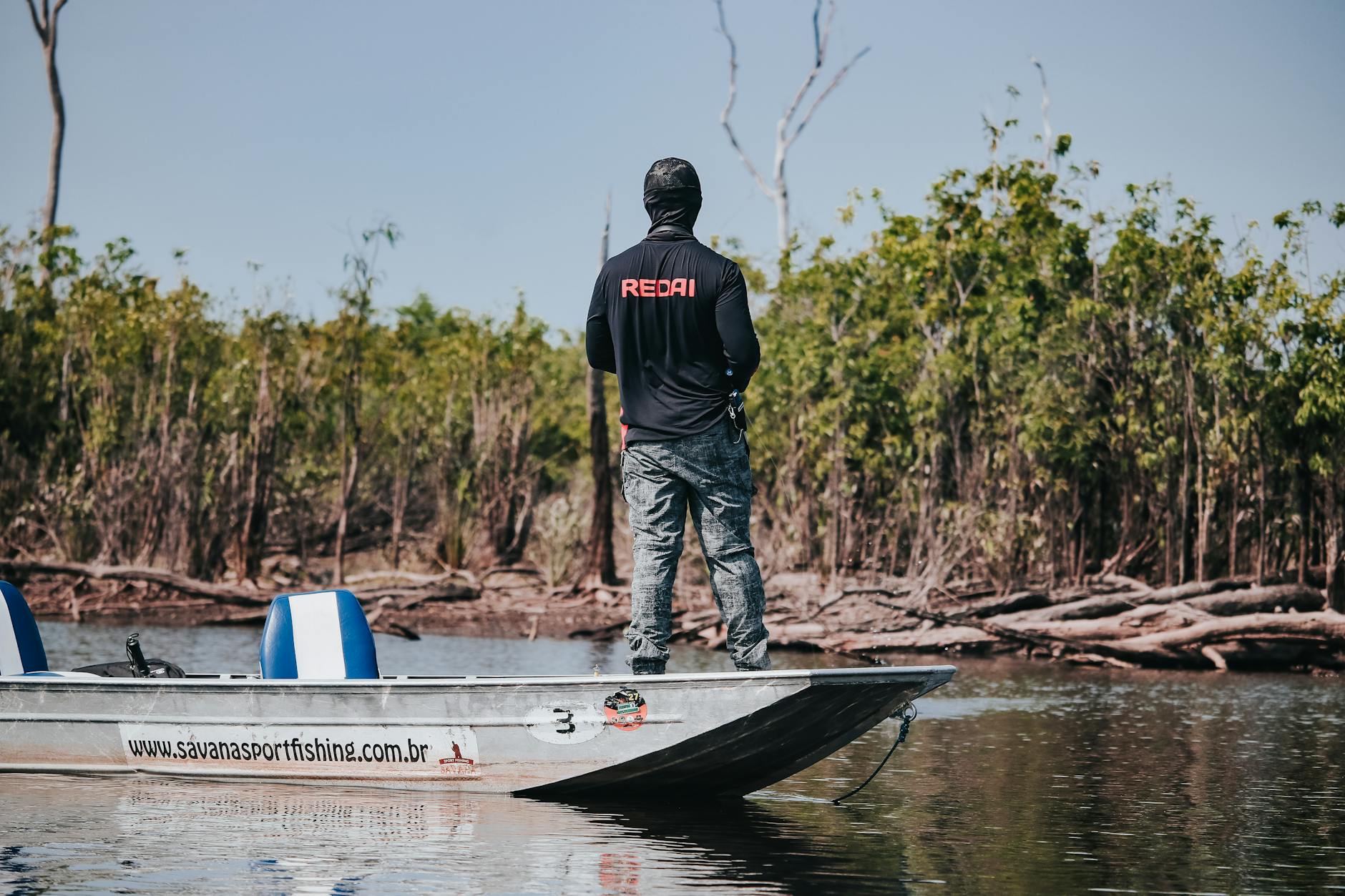 Angler battling a fish from the deck of a Miami sportfishing boat