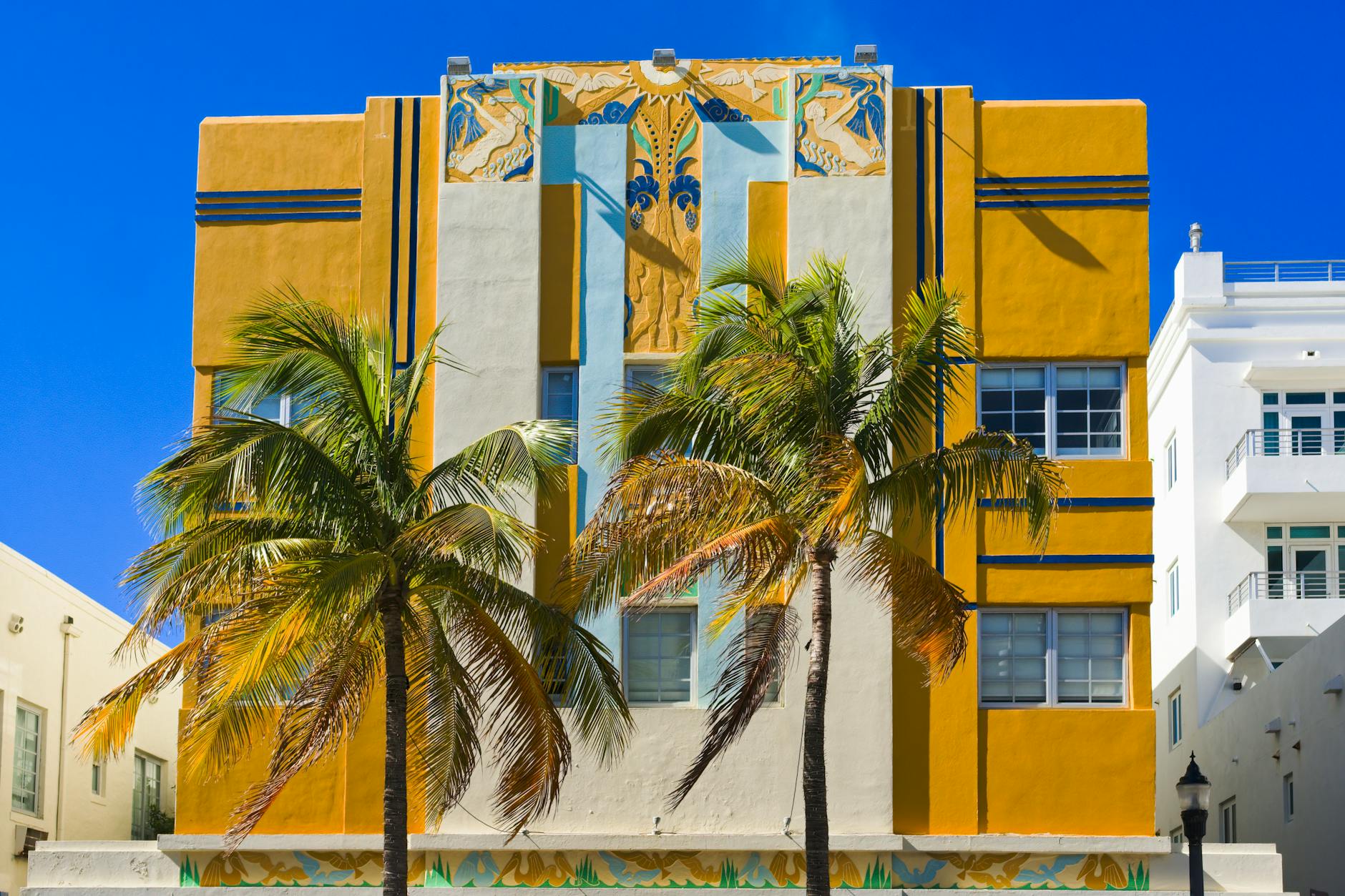 Colorful Art Deco buildings with palm trees lining South Beach Miami