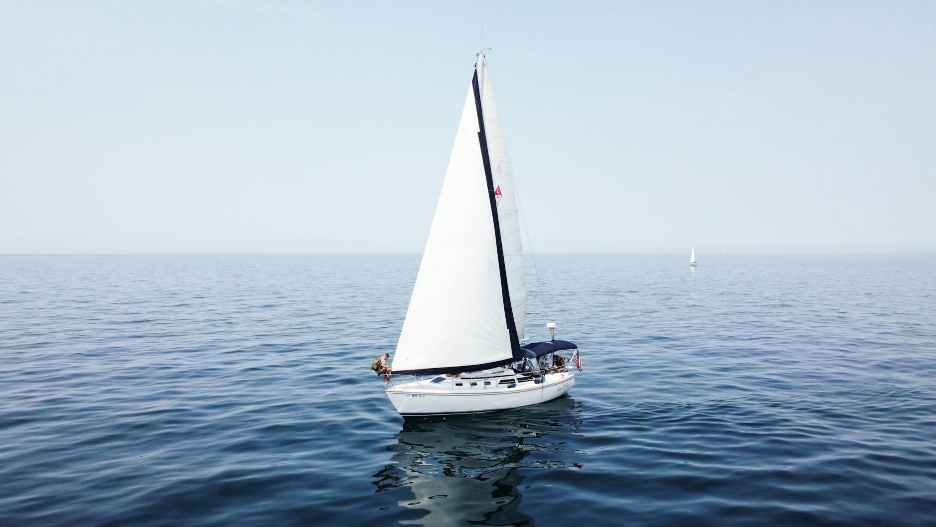 Sailboat cruising blue water off Miami's coast
