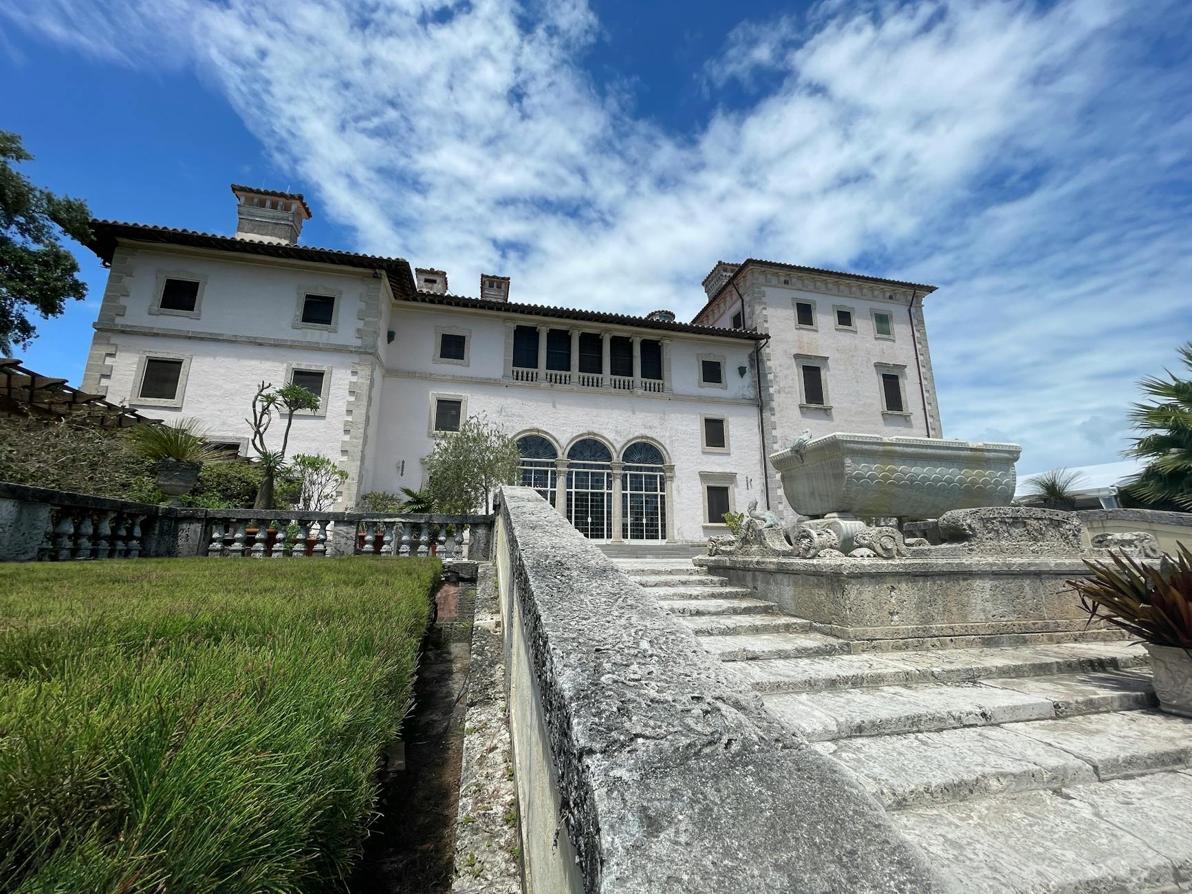 Historic Vizcaya Museum facade with ornate stone fountain under clear blue sky in Miami