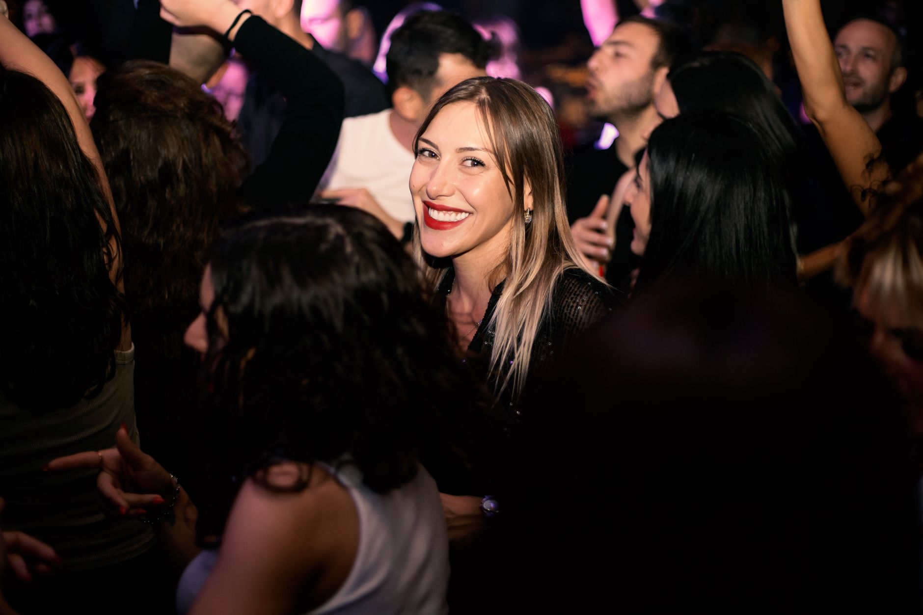 Crowd dancing under lights at a Miami nightclub