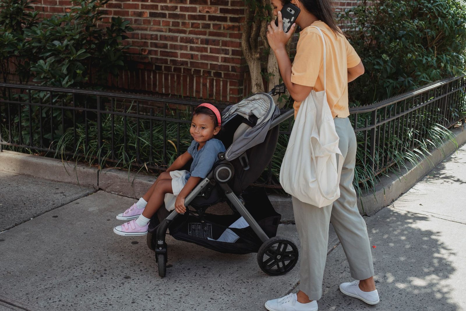family with a stroller on a city sidewalk