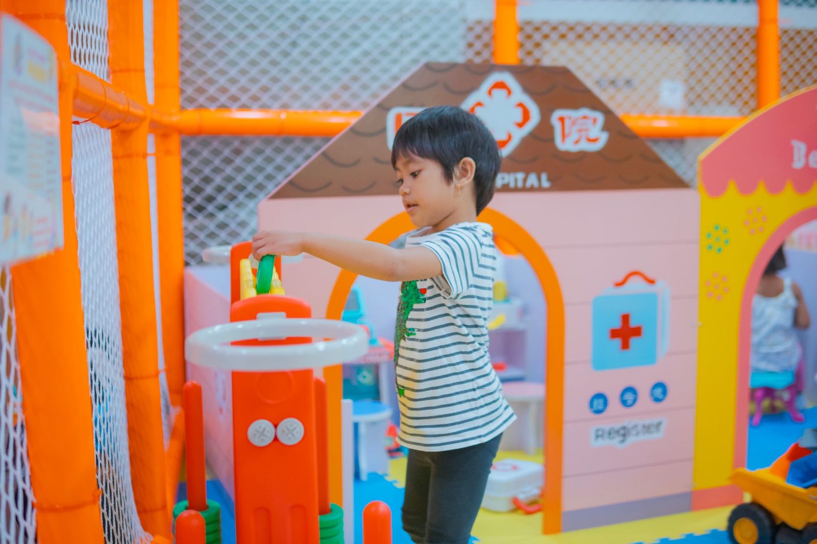 children playing in a bright indoor play space