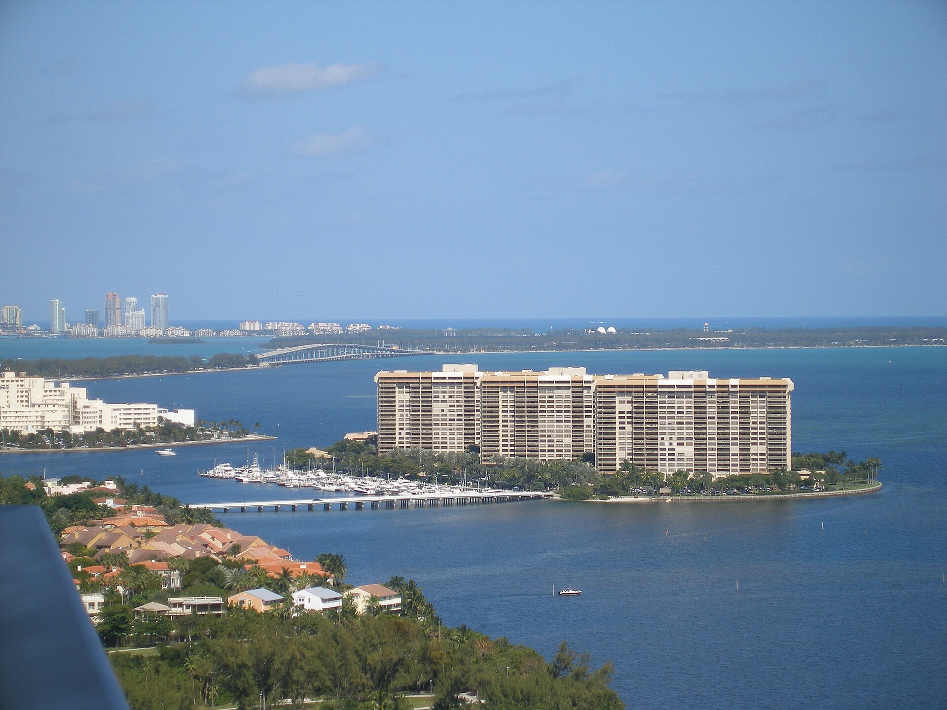 A view across Biscayne Bay from Coconut Grove, with Grove Isle and its marina in the foreground and Key Biscayne and the Rickenbacker Causeway beyond