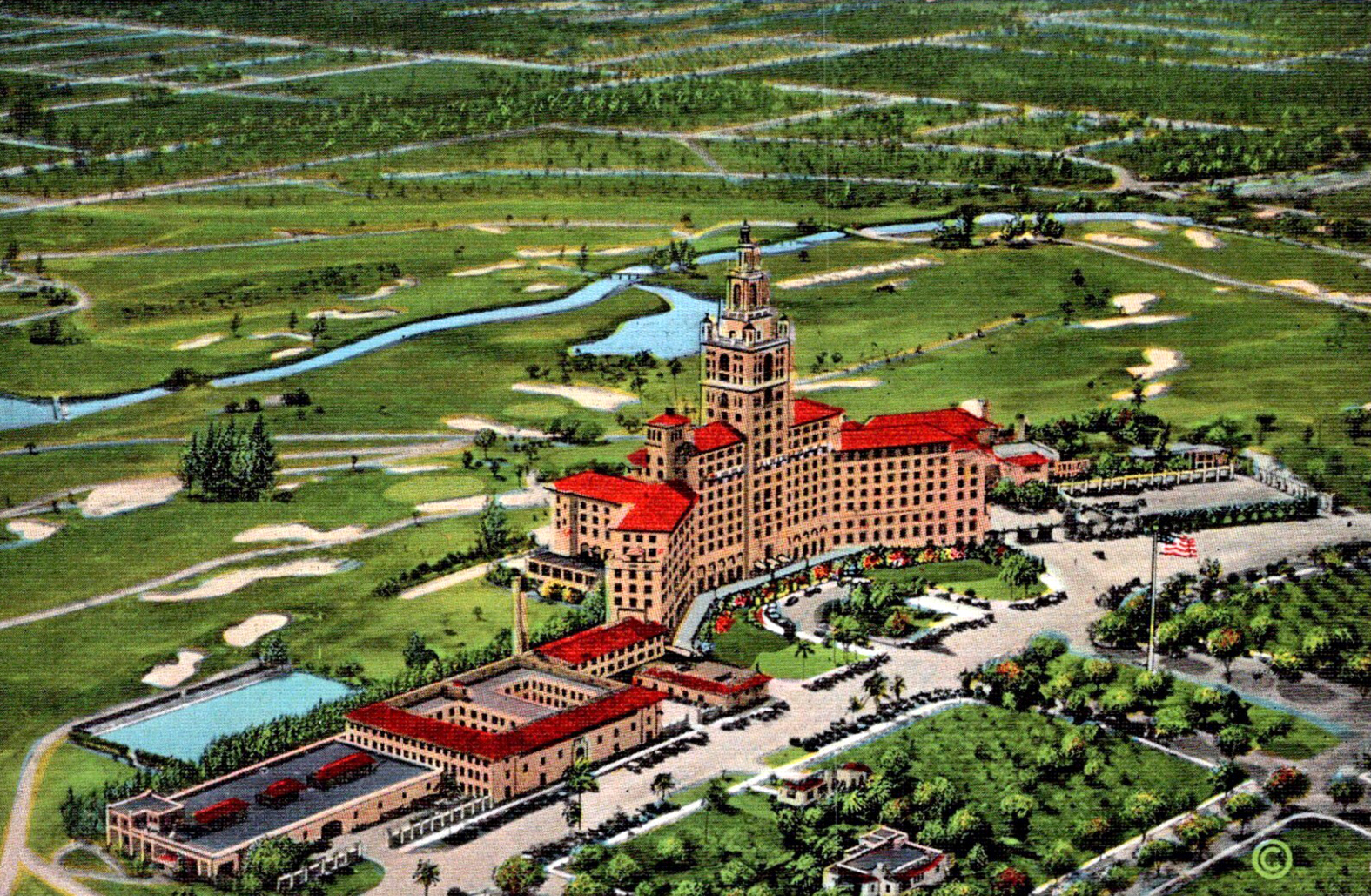 A colorized vintage postcard aerial of the Miami Biltmore Hotel and its golf course, with red-tiled roofs, the tall tower and fairways winding along a waterway