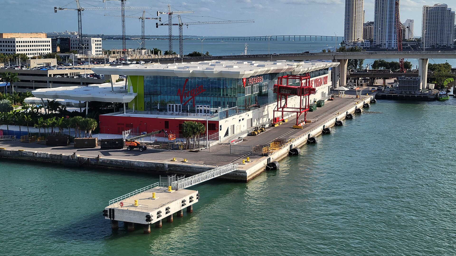 A full multi-storey parking garage beside the Virgin Voyages Terminal V building at PortMiami