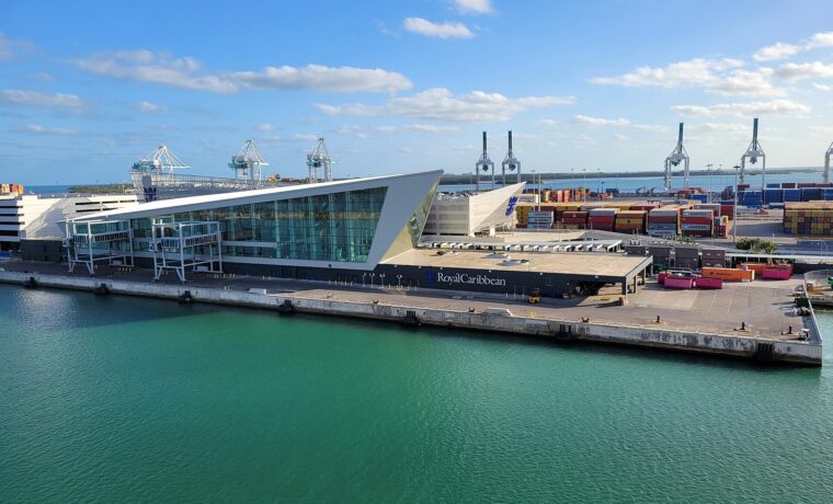 The angular glass Royal Caribbean Terminal A building at PortMiami seen from the water