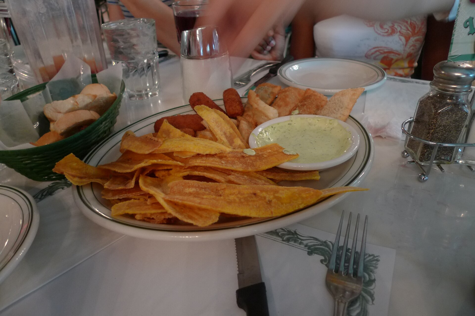 Ham croquettes sit behind fried plantain slices on an appetizer platter at Versailles Restaurant in Miami.